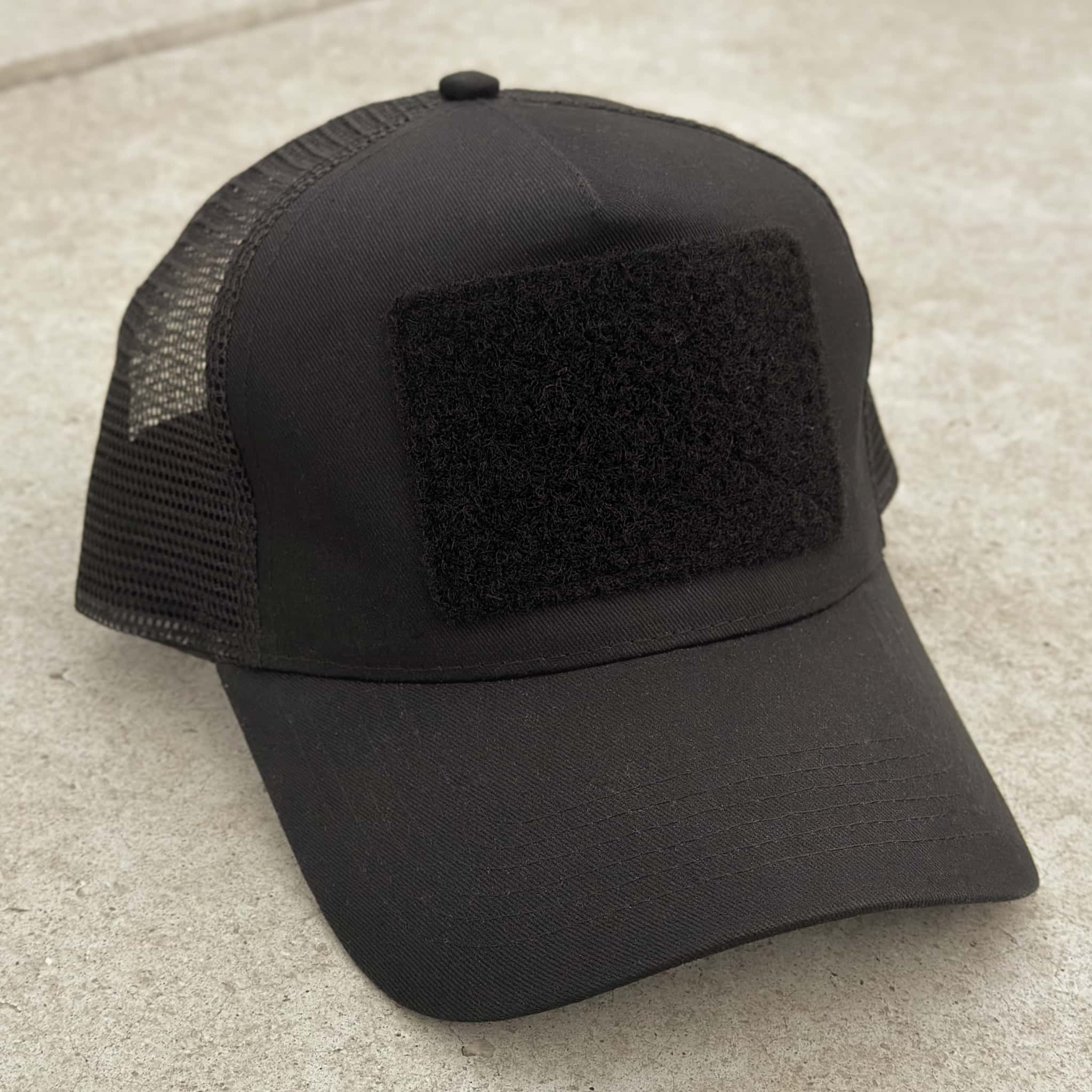 The Blank Canvas Snapback Cap in black color with large hook-and-loop area on the front