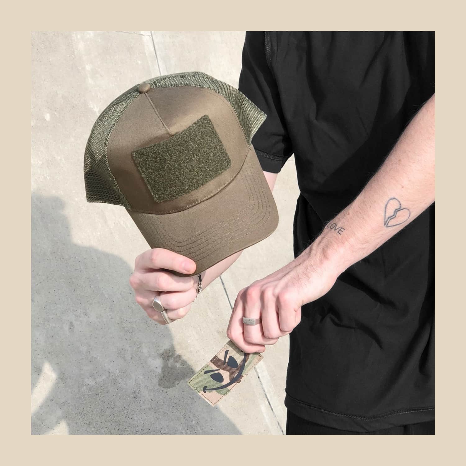Model holding the Smiley Cap with the patch off